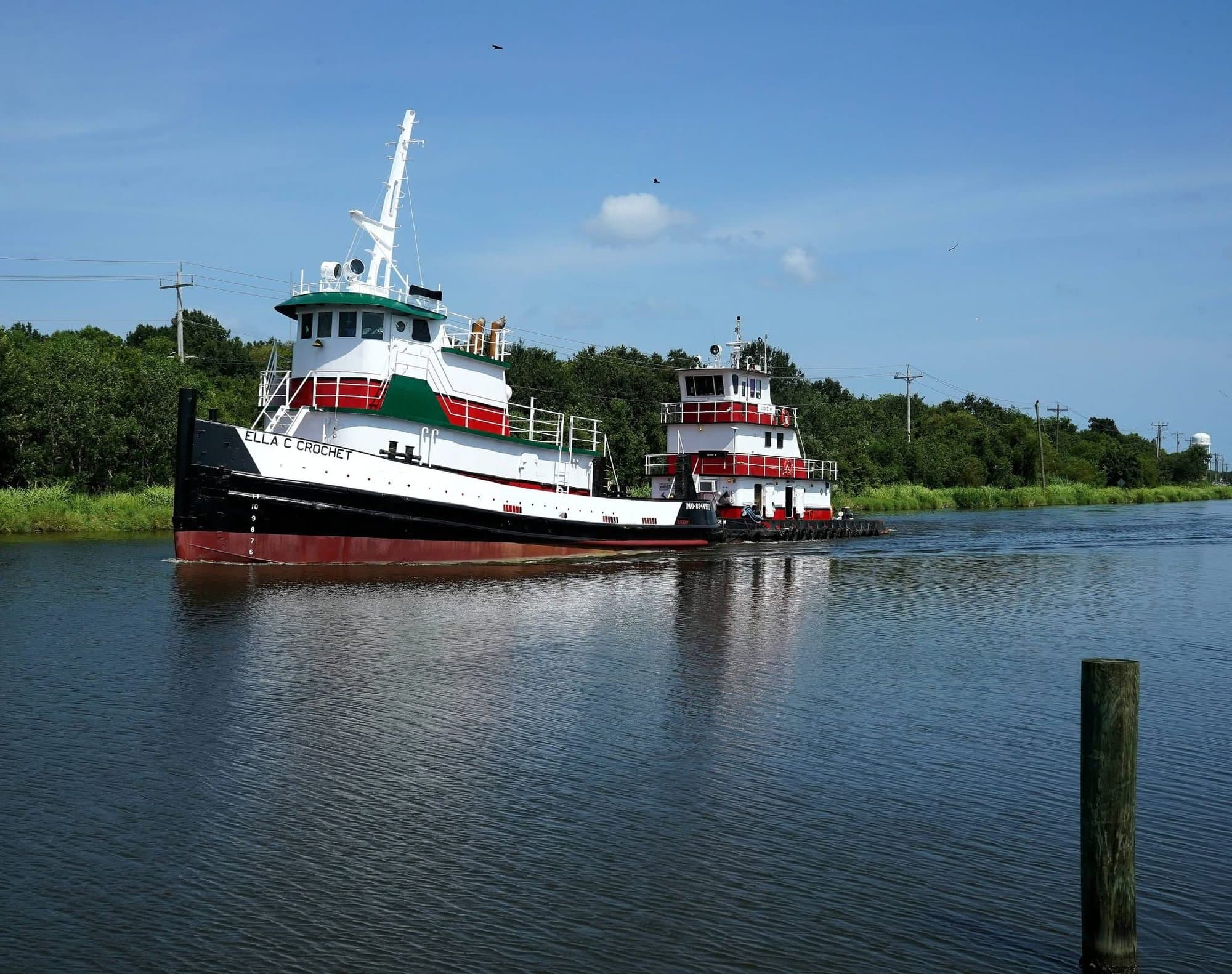 Melancon Marine tugboat pushing a vessel down the Intracoastal Waterway in South Louisiana