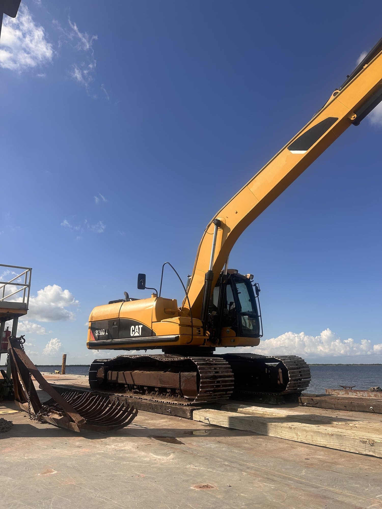 Long-reach excavator working at the water edge on a South Louisiana job site